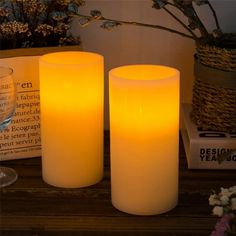 three lit candles sitting on top of a table