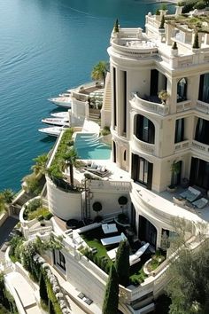 an aerial view of a mansion overlooking the water