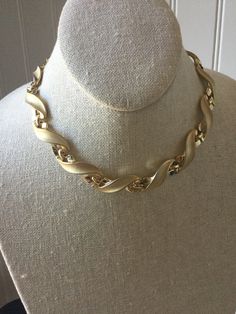 This gorgeous vintage statement choker has satin gold and shiny links, signed TRIFARI.  IT shimmers as the light bounces between the two contrasting finishes, giving this designer piece a fabulous look.  Choker necklaces are always in style and fashionable!  This piece is in very good vintage condition. TRIFARI was a top costume jewelry manufacturer in America in past decades,  producing highly crafted quality pieces that were always fashion forward.  Their jewelry is much valued by collectors today. Thanks for shopping alliesjewelbox.Etsy.com Jan Luxury Gold Choker With Intricate Design, Luxury Vintage Choker Necklace, Luxury Vintage Gold Choker, Luxury Yellow Gold Formal Choker, Luxury Yellow Gold Choker For Formal Occasions, Retro Gold Chain Necklace For Formal Occasions, Gold Retro Chain Necklace For Formal Occasions, Jewelry Manufacturer, Vintage Trifari