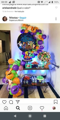 a table with balloons and other items on it in front of a tweety party