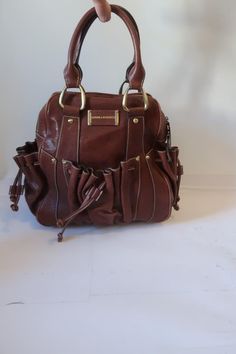 *NWT Womens Sondra Roberts Brown Leather Satchel Handbag COLOR: BROWN BRASS-TONED HARDWARE ZIPPER CLOSURE ONE MAIN COMPARTMENT 1-INTERIOR ZIPPER POCKET 2-INTERIOR SLIP POCKETS 2- EXTERIOR DRAWSTRING SIDE END POCKETS DOUBLE STRAP HANDLE MATERIAL: 100% LEATHER MEASUREMENTS (FLAT): DEPTH: 5" HEIGHT: 11.1" WIDTH: 11.6" HANDLE DROP: 5.5" NWT, NEW WITH TAGS.   (BAG-2) ...clts-trl601-4 Pictures sell! Auctiva offers Free Image Hosting and Editing. The complete eBay Selling Solution. Track Page Views With Auctiva's Counter Drawstring Handbag, Brown Leather Satchel, Ebay Selling, Leather Satchel Handbags, Satchel Handbag, Bag Design, Satchel Handbags, Denim Mini, School Bag