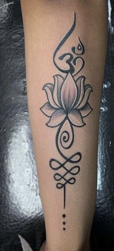 a woman's leg with a lotus tattoo on it