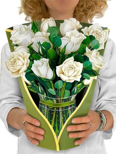 a woman holding a bouquet of white roses