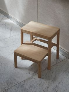 two wooden stools sitting next to each other