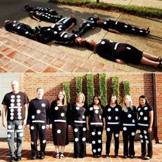 several people are dressed up in black and white polka dot outfits, one is laying on the ground