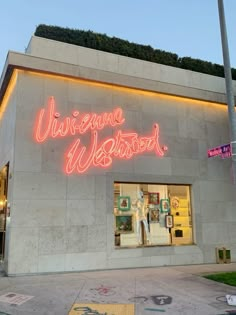 the outside of a store with neon lights