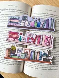 an open book with some stickers on it's pages and two bookshelves in the background