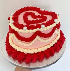 a red and white cake with hearts on it