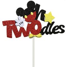 a mickey mouse cake topper that says two sides