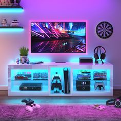 a television that is sitting on top of a entertainment center in a room with purple lighting