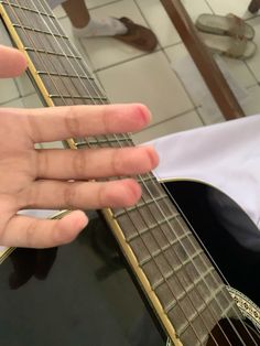 someone is playing the guitar with their fingers