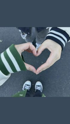 two people making a heart with their hands