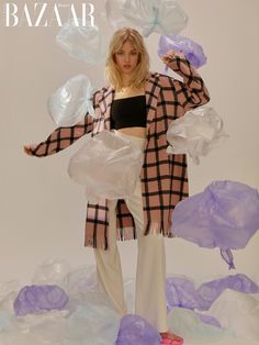 a woman standing in front of plastic bags