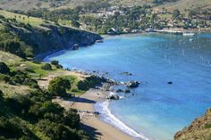 an aerial view of a beach with boats in the water