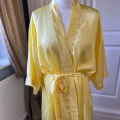 This beautiful sun yellow silk bathrobe/ dressing gown is perfect for you and your bridesmaids/ bridesmen to wear whilst getting ready for your special day. Or it can be given as a special gift for a Birthday, Mother's Day or any other special occasion.  It is made in three sizes,  UK 8-16, UK 20-24 and UK 26-30. The plus size gowns can take 2-3 weeks for delivery.     It can also be made in smaller children's sizes to fit your flower girls too -please message us for details. It can be personalized with vinyl text in Gold, Silver, Rose Gold, White, Black or Pink on both the back and front.  All items are tailor made and shipped from the UK. Available in over 30 colours. Please use the following link if you would like up to 3 fabric samples: https://www.etsy.com/uk/listing/994454470/silk-an Yellow Gown For Spring Wedding, Spring Yellow Wedding Gown, Yellow Spring Wedding Gown, Summer Wedding Gown In Gold, Gold Wedding Gown For Summer, Gold Summer Wedding Gown, Summer Wedding Satin Robe, Yellow Pajamas, Silk Bathrobe