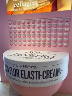 a large ice cream bowl sitting on top of a counter next to a wall mounted sign