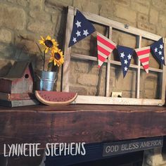 an old window frame with sunflowers, watermelon and flag bunting