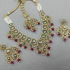 Gold Rodium Polish Red and Maroon color Necklace in Metal Alloy studded with Kundan, Pearl Luxury Ruby Necklace For Festive Season, Luxury Ruby Necklaces For Festive Season, Luxury Red Kundan Necklace For Festivals, Luxury Ruby Kundan Necklace For Festivals, Maroon Necklace, Violet Necklace, Color Necklace, Kundan Necklace, Metal Necklace