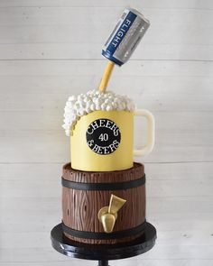 there is a cake that has been made to look like a beer mug on top of a barrel