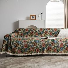 a living room with a floral couch and rug