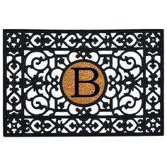 a door mat with the letter f on it and an ornamental design in front of it