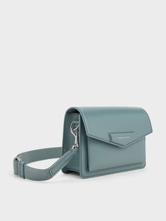 Featuring a sleek envelope-style construction and a beautiful slate-blue finish, this Adelie bag is perfect for those who love a structured bag in an eye-catching colour. It opens up to a compact interior that will hold all your daily essentials with ease -- the magnetic closure ensure easy access. This bag comes with a thick shoulder strap that offers good weight distribution, which can be easily adjusted to your preferred drop length. Walk The Line, Structured Bag, Shell Station, Bag Dark, Charles Keith, Slate Blue, Everyday Bag, Eye Catching Colors, Magnetic Closure