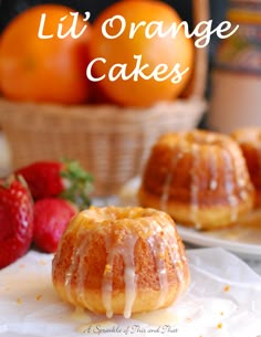 a bundt cake sitting on top of a white napkin next to oranges and strawberries