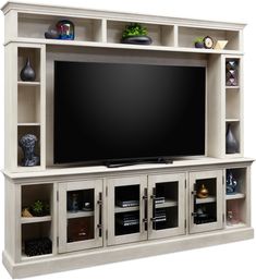 a large entertainment center with shelves and a flat screen tv on the top, in front of a white background