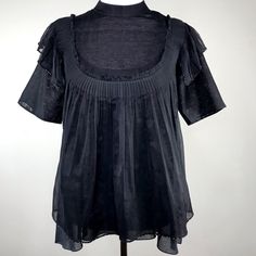 Black Handwoven Sheer Chanderi Top High Collared Neck Pleated Front Bodice Detailing Short Sleeves With Ruffled Layer Finished With Glass Bead Detail Loose Flowing Fit That Moves With Your Body Black Solid Adjustable Tank Layer Women's Size S Approximate Measurements Of Black Blouse Armpit To Armpit: 18 In. Shoulder Seam To Cuff: 11.5 In. Length Top Of Shoulder To Bottom Hem: 25 In. Gothic Ruffled Blouse For Spring, Spring Gothic Blouse With Ruffles, Gothic Black Blouse For Spring, Black Gothic Blouse For Spring, Gothic Black Blouse For Night Out, Gothic Short Sleeve Tops For Spring, Black Summer Blouse For Layering, Black Gothic Short Sleeve Blouse, Fitted Black Blouse For Daywear