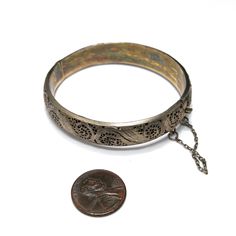 *Description: This is a beautiful Art Nouveau hinged silver bracelet with a gold wash from around the 1920s. It has European origins with stamps for silver and one difficult to read on the clasp. Photo is included. This silver bracelet with a gold wash was tested by me and tested for silver and minimum 10K gold wash or vermeil. The clasp and hinge are in great working order. If you are looking for a wonderful heirloom gift, this would be perfect. This bracelet would be a great addition to your v Vintage Hinged Gold Bracelet, Antique Sterling Silver Round Bracelet Collectible, Antique Round Sterling Silver Collectible Bracelet, Vintage Gold Bracelet For Ceremonial Occasions, Vintage Gold Bracelet With Intricate Design, Vintage Hallmarked Sterling Silver Bracelet, Antique Hinged Round Bangle, Hallmarked Vintage Sterling Silver Bracelet, Adjustable Antique Sterling Silver Bracelet