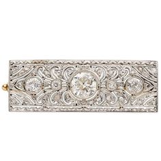 This early 20th century brooch from the Art Deco era features a 0.95 carat European cut diamond at the center, which is enhanced by 0.45 carats of European cut and rose cut diamonds. Set in 14K yellow gold with a platinum top. Brooch Length: 1 7/16 inches Brooch Width: 1/2 inch Art Deco Diamond Brooch, Period Jewelry, Brooch Art, Art Deco Brooch, Gold Brooch, Antique Brooches, Diamond Brooch, 1920s Art Deco, Geometric Diamond