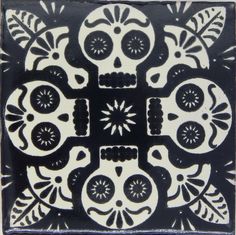 a black and white tile with skulls on it