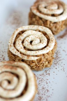 cinnamon roll cookies are shown on a baking sheet and then rolled up in the shape of spirals