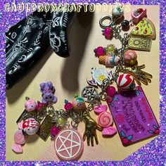 Welcome to my shop!  Here I've made a super chunky yet lightweight charm bracelet in Girlcore Spooky Slumber Party theme!  Inspired by girl gangs!  Silver tone 8" steel chain with an easy to use circle and bar toggle closure. Features pink, purple, and both gold and silver tone charms.  Friends circle round for answers and scares!  A night full of ouija boards, pizza, teddy bears, tarot, and candy...   Pink pentacles, iridescent candy beads, gold toned palm reader and tarot card charms, ice crea Harajuku Style Halloween Jewelry Gift, Customized Pink Novelty Jewelry, Handmade Themed Pink Jewelry, Handmade Pink Themed Jewelry, Pink Charms Bracelets Novelty Style, Pink Novelty Bracelets With Charms, Handmade Pink Jewelry For Halloween, Themed Handmade Pink Bracelets, Pink Handmade Themed Bracelets