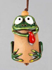 a ceramic frog ornament hanging from a cord with a red bell on it's ear