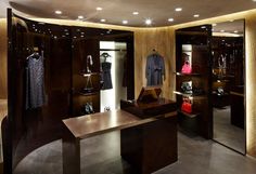 the inside of a clothing store with wooden walls