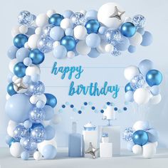 a blue and white birthday party with balloons