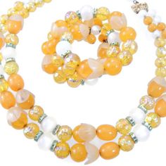 Presented by EclecticVintager , This stunning Hobe Demi Parure is a true testament to vintage designer jewelry. The double strand chunky beaded necklace and wrap bracelet feature a captivating combination of yellow and white beads, creating a harmonious and eye-catching color palette. Crafted with meticulous attention to detail, this set exudes timeless elegance and charm. The double strand necklace gracefully drapes around the neck, accentuating any outfit with its vibrant hues and chunky beads. Its length is perfect for showcasing the intricate beadwork and allowing the piece to make a statement. The matching wrap bracelet beautifully complements the necklace, offering versatility and style. With its adjustable design, it can be worn snugly around the wrist or elegantly wrapped around th Cheap Yellow Multi-strand Jewelry, Luxury Double Strand Statement Jewelry, Luxury Vintage Jewelry With Spacer Beads, Multi Strand Beaded Necklace, Vintage Designer Jewelry, Coil Bracelet, Vintage Jewelry Sets, Double Strand Necklace, Chunky Beads