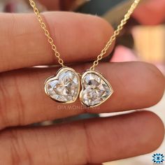 Handcrafted Elegance for Every Day: Dive into the world of bespoke jewelry with our Twin Stone Heart Shaped Pendant, meticulously handcrafted for the modern woman. Whether it's a day at the office or a night on the town, this piece is your new go-to. Moissanite Magic: Delight in the dazzling sparkle of 4-carat moissanite. Set in a sophisticated bezel, this pendant promises brilliance that mirrors diamonds. 14kt Yellow Gold Luxe: Immerse yourself in the timeless allure of 14kt yellow gold. It's n Luxury Bezel-set Heart Cut Jewelry, Luxury Bezel Set Jewelry For Valentine's Day, Luxury Jewelry With Bezel Setting For Valentine's Day, Luxury Heart Cut Bezel Set Jewelry, Luxury Heart-shaped Jewelry With Bezel Setting, Gia Certified Heart-shaped Diamond Jewelry, Fine Jewelry Heart-shaped Gia Certified, Gia Certified Fine Heart Shaped Jewelry, Heart Cut Moissanite Jewelry With Brilliant Cut