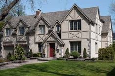 a large house with lots of windows in the front yard