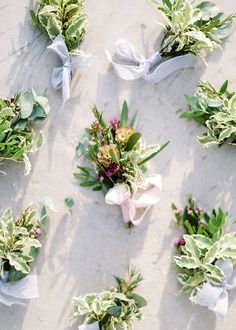 wedding flowers laid out on the beach