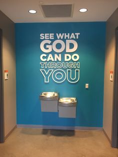 two trash cans sitting in front of a wall that says see what god can do through you