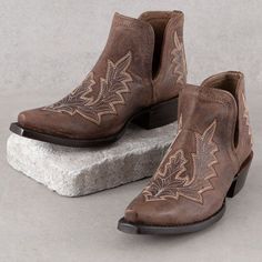 Ariat Brown Low Heel Dixon Booties Western Brown Boots With Stitched Sole, Brown Western Boots With Stitched Sole, Western Style Boots With Cushioned Footbed, Western Slip-on Boots With Reinforced Heel, Western Style Closed Toe Boots With Cushioned Footbed, Western Style Cushioned Closed Toe Boots, Western Boots With Cushioned Footbed And Snip Toe, Western Slip-on Boots For Fall, Western Style Leather Work Boots With Closed Toe