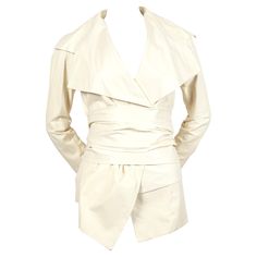 Off-white lambskin leather jacket with unique wrap closure designed by Tom Ford for Yves Saint Laurent spring 2004 exactly as seen on the runway. Belt can be worn at waist or hips. Jacket is labeled a French size 38 although this also fits a FR 36. Measurements are difficult to take due to the wrap closure. Fully lined in silk. Made in Italy. New including tags with a few faint marks from storage. Luxury Cream Leather Jacket, Leather Runway, Tom Ford Jacket, Chic Closet, Color Crema, Designer Jackets, Lambskin Leather Jacket, Designer Pieces, Jacket Design