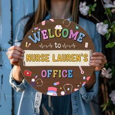 a woman holding a sign that says welcome to nurse lauren's office