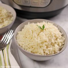 two bowls filled with rice next to an instant pressure cooker