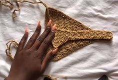 a woman's hand on top of a piece of cloth