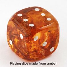 a close up of a dice with white dots on the top and bottom part,