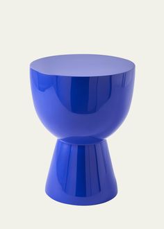 a blue vase sitting on top of a white table