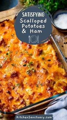 a casserole dish with meat and cheese in it on a wooden table next to utensils